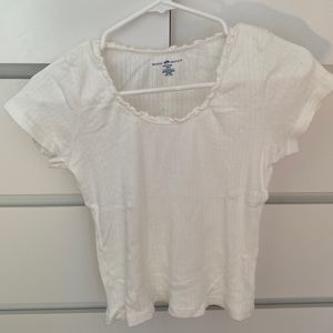 white top, laced/scrunched neckline, normal length (not cropped)